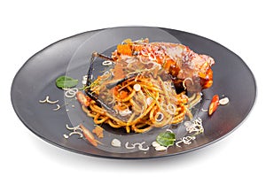 Spicy Pasta with seafood with herbs and spices in Black dish iso