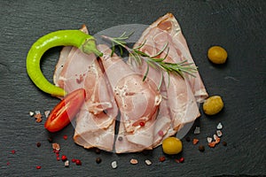 Spicy pork ham slices on black board