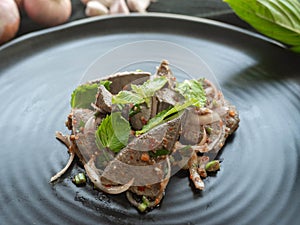 Spicy Pork Liver Salad,Ingredient Onion,Roasted rice,Basil,Pepper,On a black plate,Thai Street Food