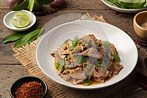 Spicy Pork Liver Salad (Tub Wan) in white plate.