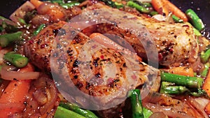 Spicy pork loins cooking with a lot of vegetables