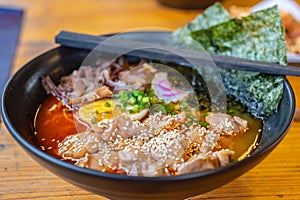 Spicy ramen Japanese noodle soup in a black color ramen bowl