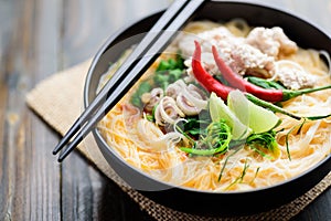 Spicy rice noodles soup with spices and herbs Thai Tom Yum