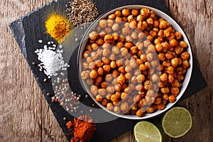 Spicy Roasted chickpeas in a bowl and ingredients close-up. horizontal top view photo
