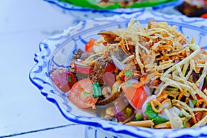 Spicy salad with meat and tomatoes and fruits