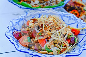 Spicy salad with meat and tomatoes and fruits