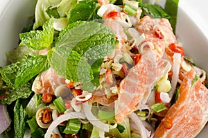 Spicy salmon salad on white background