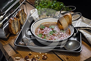 Spicy soup Kharcho on wooden background