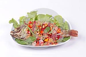 Spicy and sour fried Tilapia Salad with baby tamarind leaves .