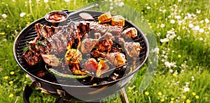 Spicy spare ribs and chicken grilling on a BBQ