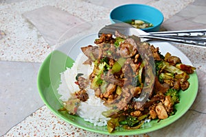 Spicy stir-fried chicken innards with basil leaves on rice