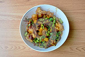 Spicy stir fried pork ligament with herb on bowl