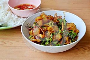 Spicy stir fried pork ligament with herb and plain rice