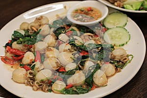 Spicy stirred fried scallop with a variety of Thai herb such as ginger, chili, pepper, galingale.