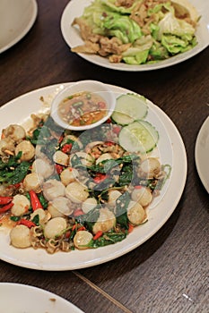 Spicy stirred fried scallop with a variety of Thai herb such as ginger, chili, pepper, galingale.