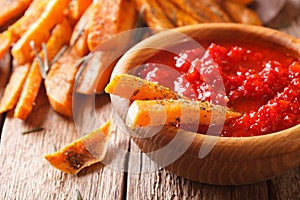 Spicy sweet potato fries with herbs and ketchup macro on the tab