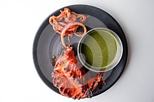 Spicy tandoori chicken Lal Badsha with chili sauce served in a dish isolated on grey background top view of bangladesh food