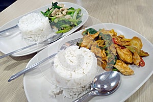 Spicy Thai food portions on two plates