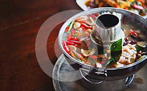 Spicy thai food soup sercve with hot iron pot