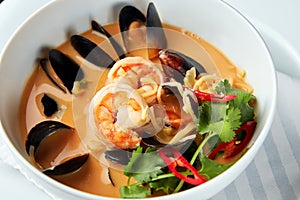 Spicy Thai soup Tom Yam with seafoods