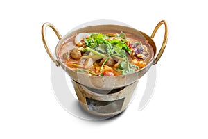 Spicy Thai traditional food ` Tom Yum Goong Sea Food ` in the brass hot pot.