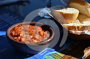 Spicy Tomato and chili pepper sauce dressing and bread at chilean restaurant photo