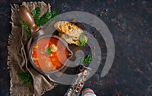 Spicy tomato soup with meatballs, pasta and vegetables.