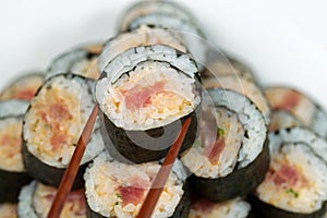 Spicy Tuna Roll being selected with Chopsticks