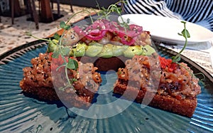 Spicy Tuna Tartare On Fried Sushi Rice And Teriyaki Shrimps With Avocado Mash