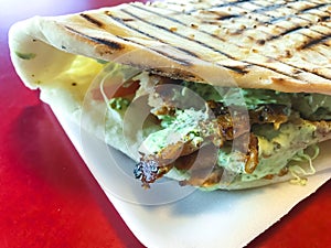 Spicy turkish doner kebab filled with roasted meat, fresh salad  and garlic sauce in toasted tortilla.