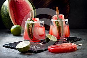 Spicy watermelon popsicle margarita cocktail with jalapeno and lime. Mexican alcoholic drink for Cinco de mayo party.