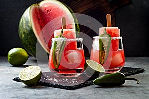 Spicy watermelon popsicle margarita cocktail with jalapeno and lime. Mexican alcoholic drink for Cinco de mayo party. photo