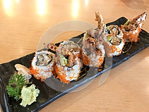 Spider Roll Japanese Food made from deep fried Crab Meat, Egg, Avocado, Cucumber inside.
