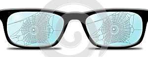 Spider webs and spiders are seen in or on a pair of old no longer used eyeglasses