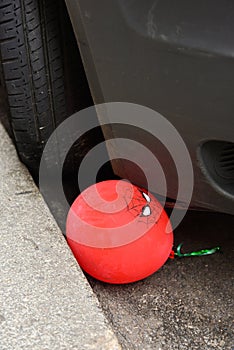 Spiderman Balloon Crushed Between Car and Sidewalk