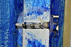 Spiegele iron latch on a blue painted door