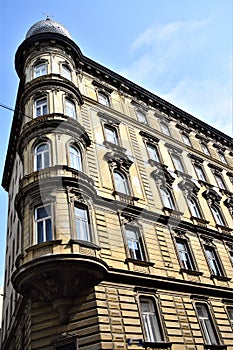 Spigolo, with spherical dome, on the roof of a historic and elegant building in Vienna, with sky and white clouds.