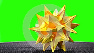 Spiked origami star on green screen.