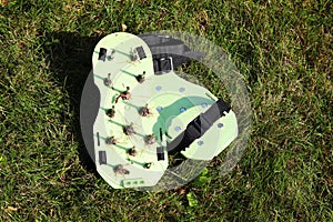 Spiked shoes liven up the lawn. Lawn aeration. gardening concept. Garden care