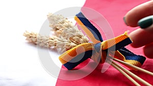 Spikelet of wheat, tied with a ribbon of the Ukrainian flag, are placed on the flag of Poland, the flags of Poland and Ukraine