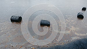 Spilled barrels of oil hit the ground