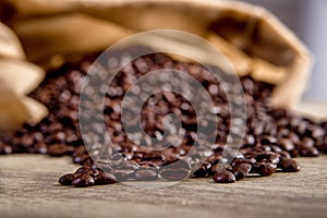 Spilled coffee beans on wooden