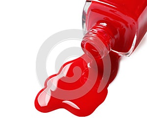 Spilled color nail polish with bottle on white