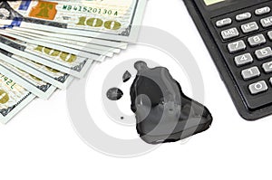 Spilled crude naphtha and dollars, calculator on a white background. Oil crisis concept.