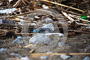 Spilled garbage on the beach.Empty used plastic bottle.
