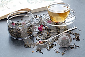 Spilled green tea with a rose on stone table