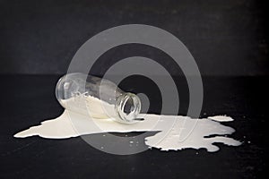 Spilled Milk on a Black Table