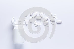 Spilled Pill Bottle isolated.Top view,.pharmacology concept. white pills