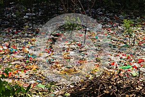 Spilled plastic garbage on the land of the big city. Empty used dirty plastic bottles. Plastic pollution. Environmental pollution.