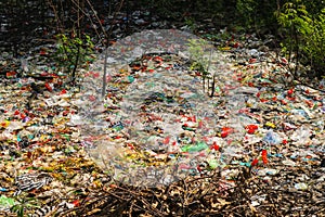 Spilled plastic garbage on the land of the big city. Empty used dirty plastic bottles. Plastic pollution. Environmental pollution.